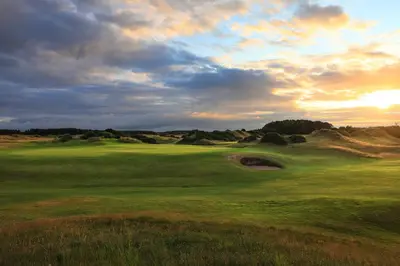 a view of a golf course with the sun setting at Dundonald Links in Dreghorn