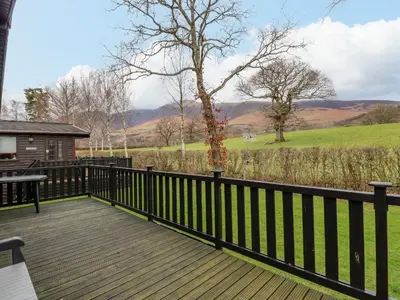 a wooden deck with a view of a field at The Fold in Keswick