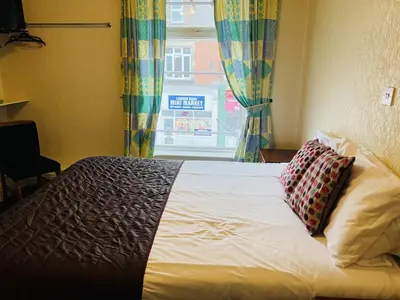a bed with two pillows sitting in front of a window at The Roadhouse Hotel in Carlisle