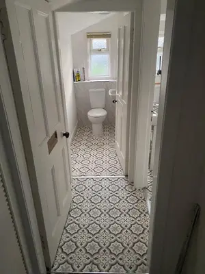 a white bathroom with a toilet and a window at Queensberry arms hotel in Kirkconnel
