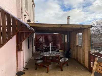 a patio with a table and a picnic table at Queensberry arms hotel in Kirkconnel