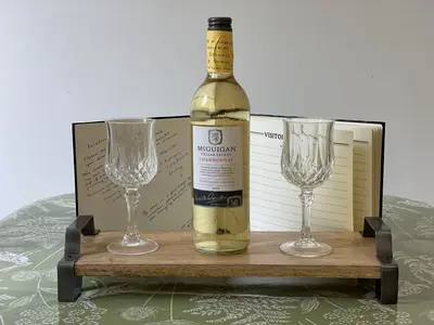 a bottle of wine and two glasses on a table at Fairbank in Keswick