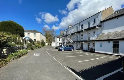 a car parked in a parking lot next to a building at Gretaside in Keswick