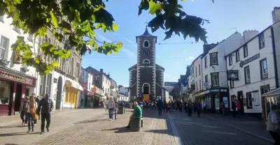 a street with a clock tower in the middle of a city at Gretaside in Keswick