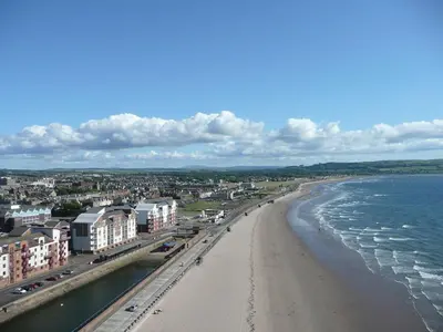 a view of a beach with buildings and the ocean at Kinfirth Apartment in Ayr