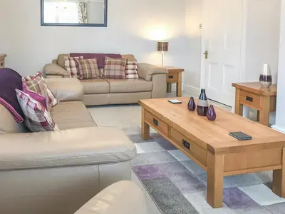 a living room with a couch and a coffee table at Upton Down in Keswick