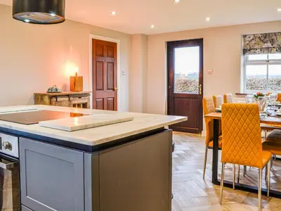 a kitchen and dining room with a table and chairs at Ellerton Croft in Wreay