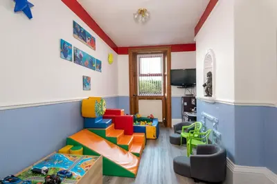 a childs room with a play area with a play set at Big Pink House in Mealsgate