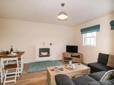 a living room with a couch and a table at Fox's Retreat in Keswick