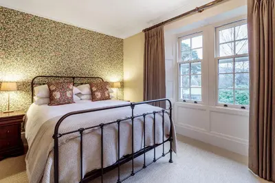 a bedroom with a bed and a window at The Vicarage in Keswick