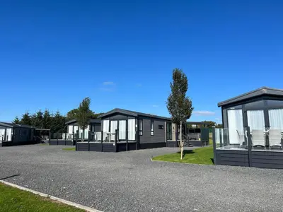 a row of modular homes in a parking lot at Arranview Lochside Pods & Lodges all with private Hot-tubs in Fenwick