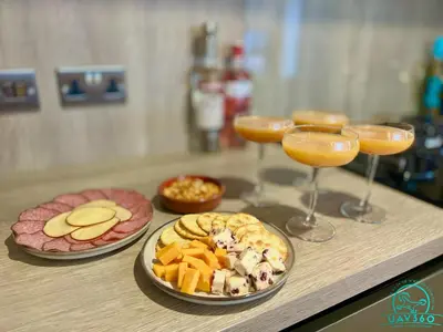a table with three plates of food and wine glasses at Arranview Lochside Pods & Lodges all with private Hot-tubs in Fenwick