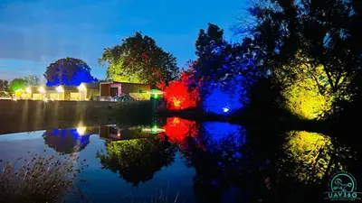 a view of a lake at night with lights at Arranview Lochside Pods & Lodges all with private Hot-tubs in Fenwick