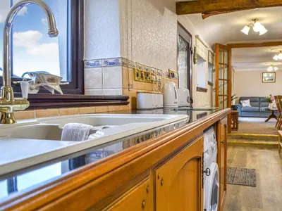 a kitchen with a sink and a counter top at Scalelands Cottage in Frizington