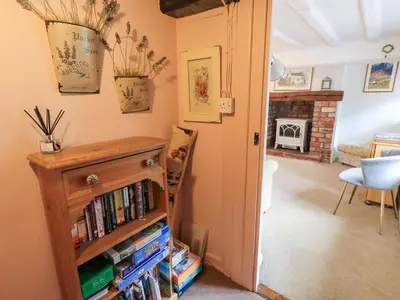 a room with a book shelf filled with dvds at Jacky Garth Cottage in Keswick
