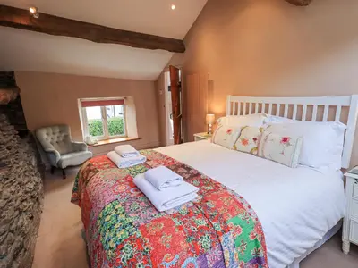 a bedroom with a large bed with towels on it at Jacky Garth Cottage in Keswick
