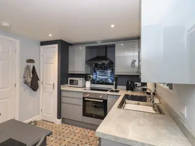 a kitchen with a sink and a stove top oven at Solway View in Wigton