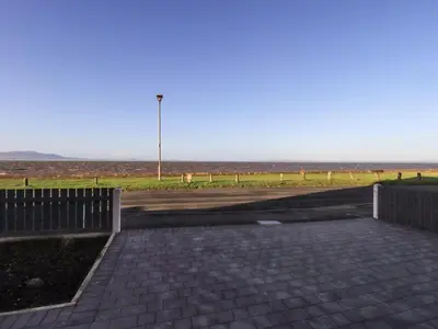 a parking lot with a street light in a field at Solway View in Wigton