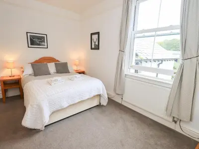 a bedroom with a bed and a large window at Hazelmere in Keswick