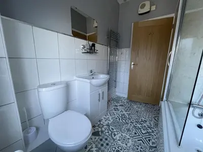 a bathroom with a toilet and a sink and a shower at Skiddaw View in Keswick