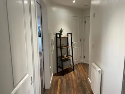 a hallway with a black shelf in a room at Niche View in Irvine