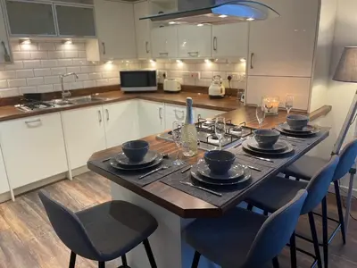 a kitchen with a large wooden table with chairs at Niche View in Irvine