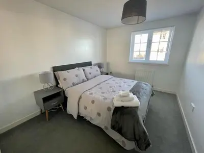 a bedroom with a large bed and a window at Niche View in Irvine