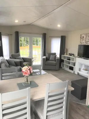 a living room with a wooden table and chairs at Cumbria Reach in Longtown