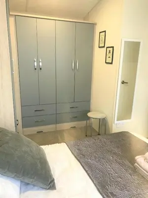a bedroom with a large wardrobe and a bed at Cumbria Reach in Longtown