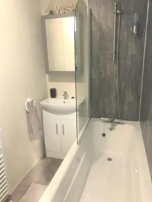 a bathroom with a tub and a sink and a shower at Cumbria Reach in Longtown