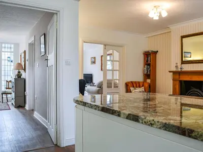 a kitchen with a counter top and a living room at Parkfield in Keswick
