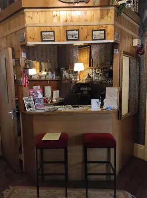 a bar in a room with two stools at it at All Seasons Guesthouse in Douglas