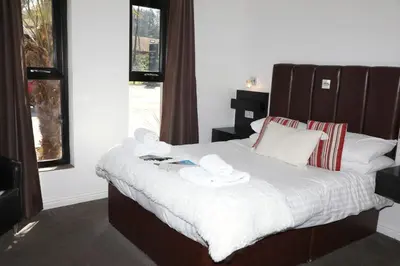 a bedroom with a bed with two dishes on it at The Inn on the Loch in Castle Douglas