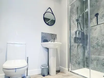 a bathroom with a toilet and a sink and a shower at 4 Mote View-Uk37497 in Sandhead