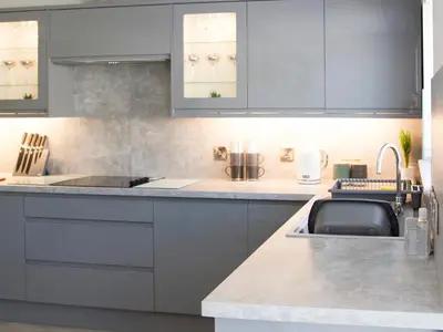 a kitchen with gray cabinets and a sink at 4 Mote View-Uk37497 in Sandhead