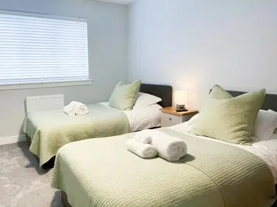 a bedroom with two beds with towels on them at 2 Mote View- Uk37496 in Sandhead