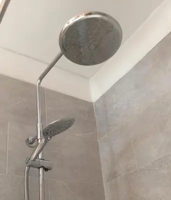 a shower with a shower head in a bathroom at Strawberry Fields in Cockermouth