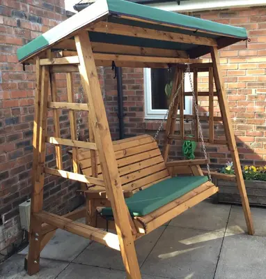 a wooden porch swing with a blue roof at Strawberry Fields in Cockermouth