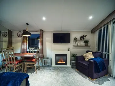 a living room with a couch and a fireplace at Bayfield in Lamplugh