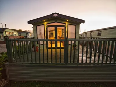 a small house with a railing on a porch at Bayfield in Lamplugh