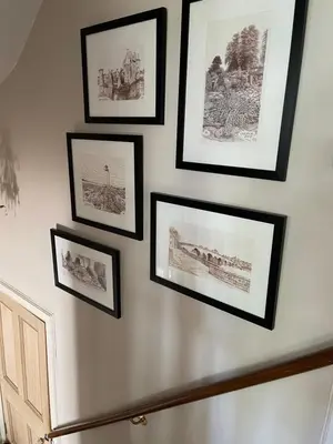 a group of pictures hanging on a wall at River View in Dumfries
