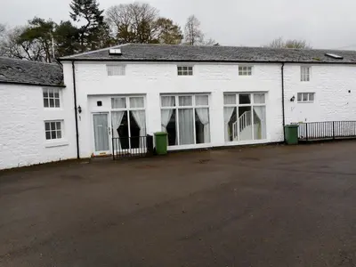 a white building with a lot of windows at THE COACH HOUSE in Moffat