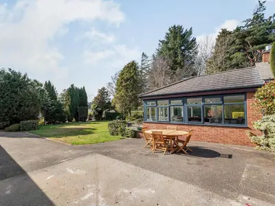 a brick house with a table and chairs at Brooksyde,Kippford in Kippford