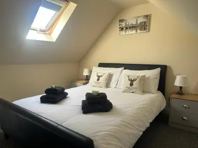 a bedroom with a bed with two towels on it at Rowan Cottage Wanlockhead Dumfries & Galloway in Wanlockhead