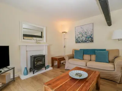 a living room with a couch and a fireplace at The Old Mill in Keswick