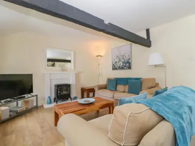 a living room with a couch and a tv at The Old Mill in Keswick