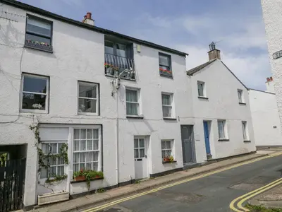 a row of white houses on a street at The Old Mill in Keswick