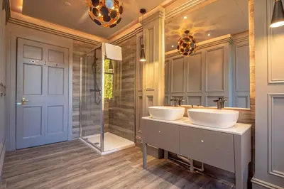 a bathroom with two sinks and a shower at Enterkine Country House Resort in Annbank