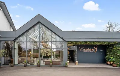 a store front with glass doors and plants at Enterkine Country House Resort in Annbank