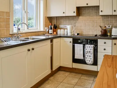 a kitchen with a sink and a dishwasher at Sinclair's in Gatehouse of Fleet